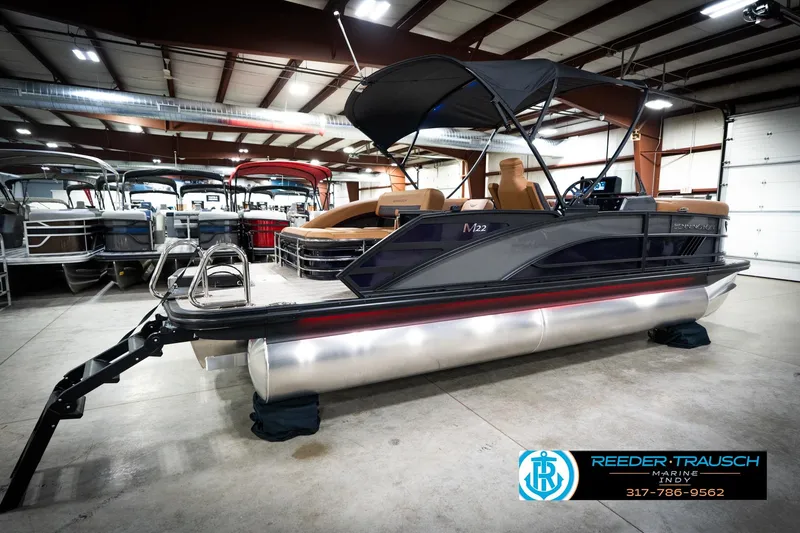 Slide: The Image of 2026 Bennington 22 MSB pontoon boat in showroom, featuring sleek design and modern amenities. - 6
