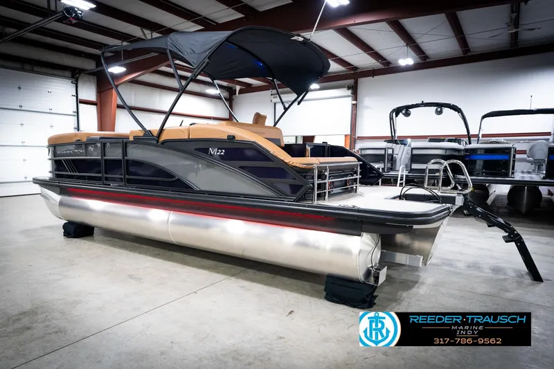 Slide: The Image of 2026 Bennington 22 MSB pontoon boat in showroom with canopy and sleek design. - 8