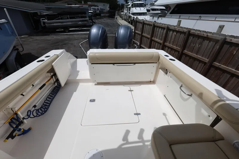 Slide: The Image of 2017 Pursuit DC 265 Dual Console boat interior with seating and storage compartments. - 14