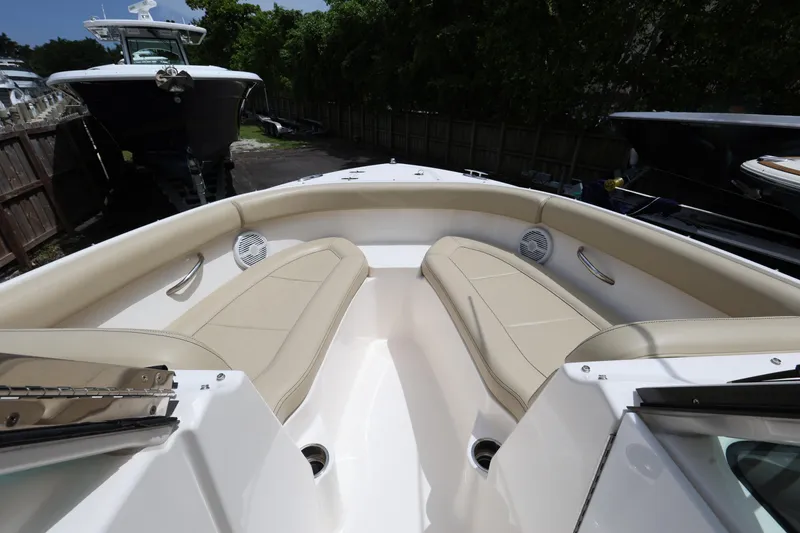Slide: The Image of 2017 Pursuit DC 265 Dual Console boat interior with beige seating and sleek design. - 15
