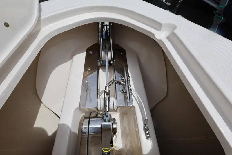 Slide: The Image of Anchor compartment of 2017 Pursuit DC 265 Dual Console boat, showcasing stainless steel fittings. - 16