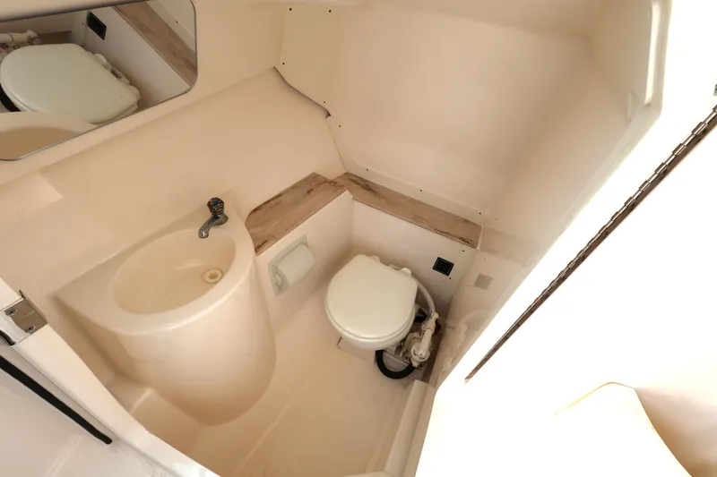 Slide: The Image of 2017 Pursuit DC 265 Dual Console boat bathroom with sink and toilet. - 20