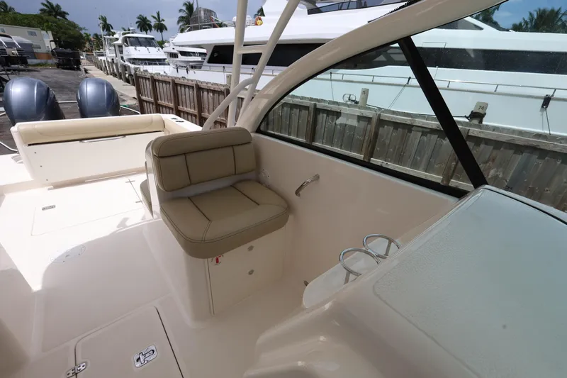 Slide: The Image of 2017 Pursuit DC 265 Dual Console boat interior with seating and cup holders. - 21