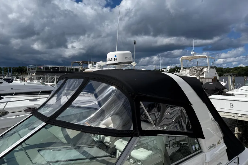 Slide: The Image of 2001 Sea Ray 310 Sundancer docked at marina under cloudy sky. - 11