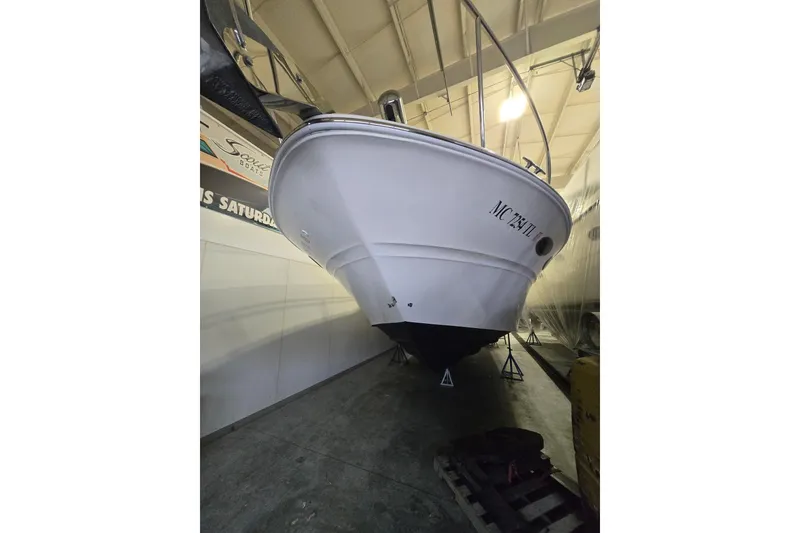 Slide: The Image of 2001 Sea Ray 310 Sundancer boat in indoor storage, viewed from the bow. - 13