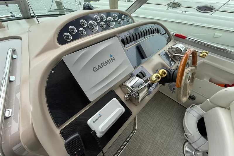 Slide: The Image of Cockpit of 2001 Sea Ray 310 Sundancer with Garmin navigation system and wooden steering wheel. - 16