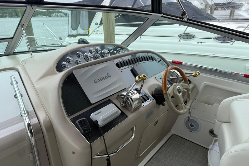 Slide: The Image of Cockpit of 2001 Sea Ray 310 Sundancer with Garmin navigation system and luxurious controls. - 17