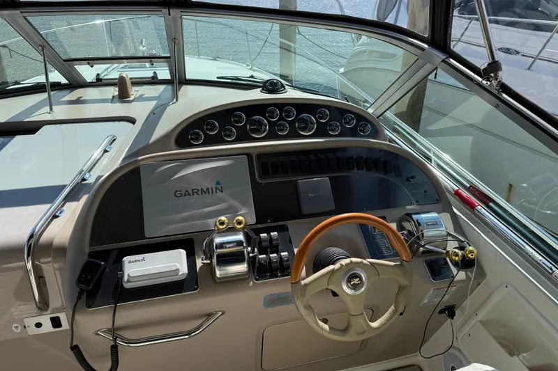 Slide: The Image of Cockpit of 2001 Sea Ray 310 Sundancer with Garmin navigation system and wooden steering wheel. - 19