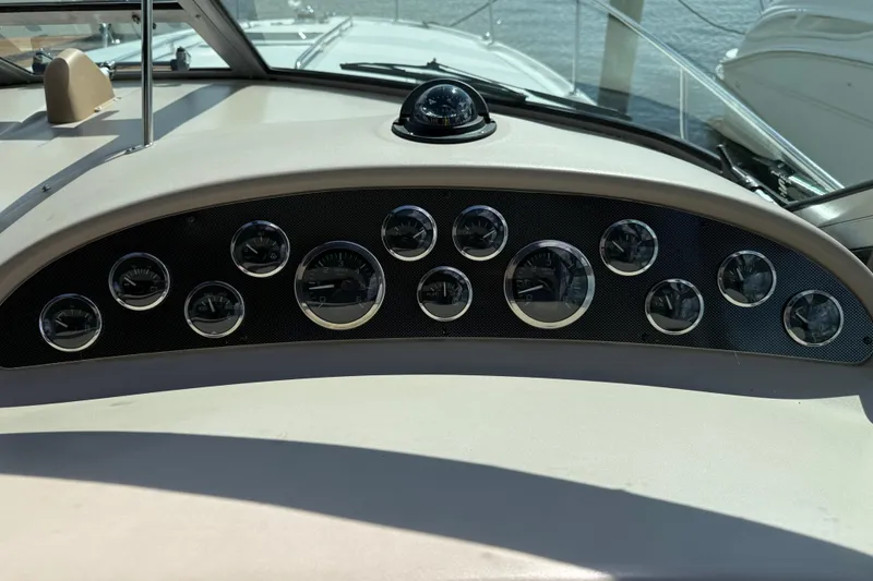 Slide: The Image of Dashboard of a 2001 Sea Ray 310 Sundancer boat with multiple gauges. - 20