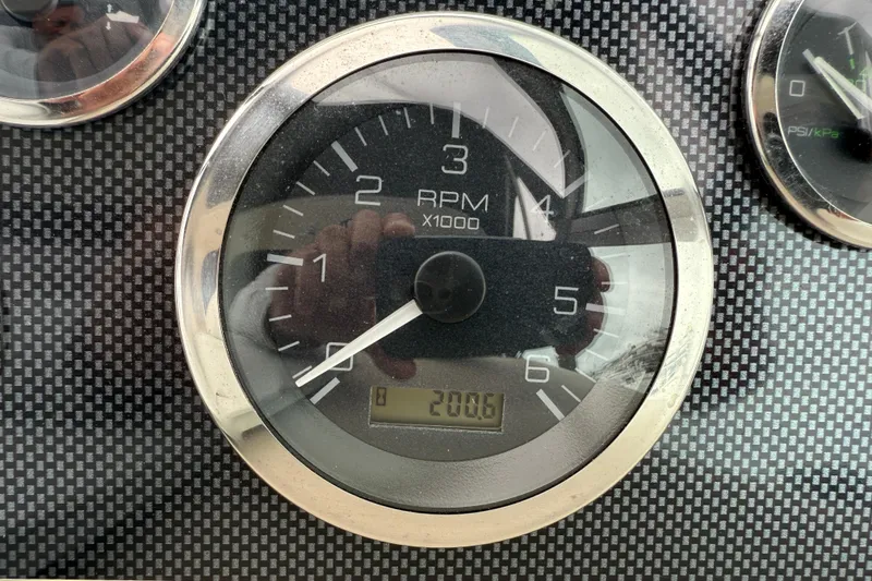 Slide: The Image of Tachometer of 2001 Sea Ray 310 Sundancer showing 2006 RPM on carbon fiber dashboard. - 22