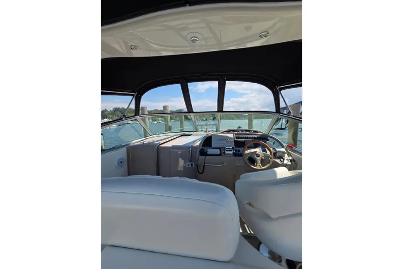 Slide: The Image of Interior view of 2001 Sea Ray 310 Sundancer boat cockpit with steering wheel. - 24