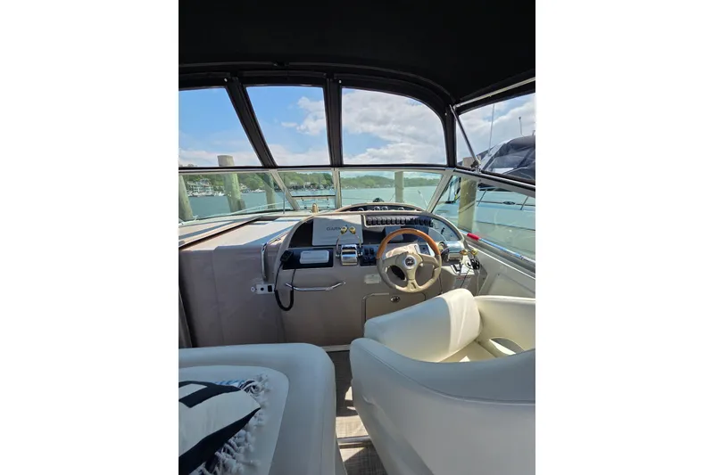 Slide: The Image of Interior view of 2001 Sea Ray 310 Sundancer boat cockpit with steering wheel. - 25