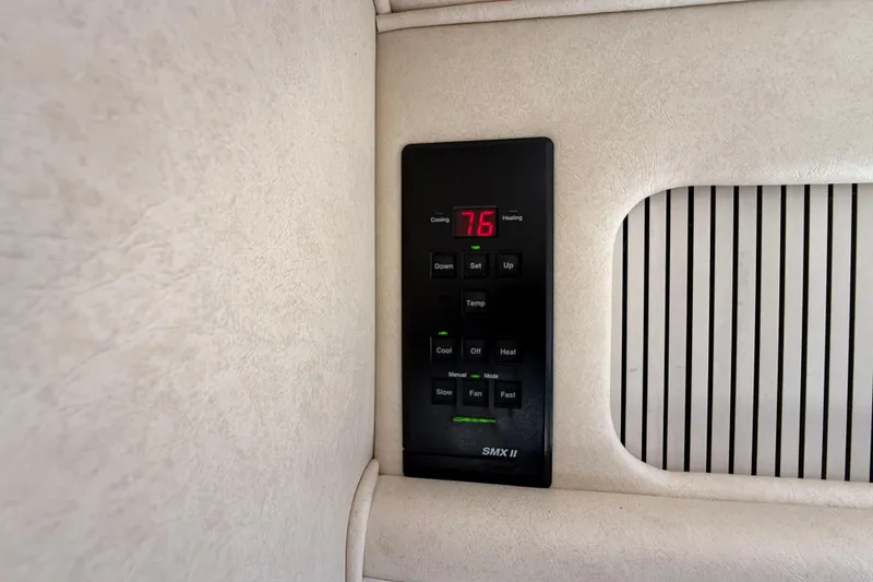 Slide: The Image of Thermostat control panel on a 2001 Sea Ray 310 Sundancer boat interior. - 34