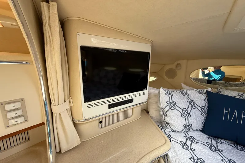 Slide: The Image of Interior of 2001 Sea Ray 310 Sundancer with TV and cozy bedding. - 35