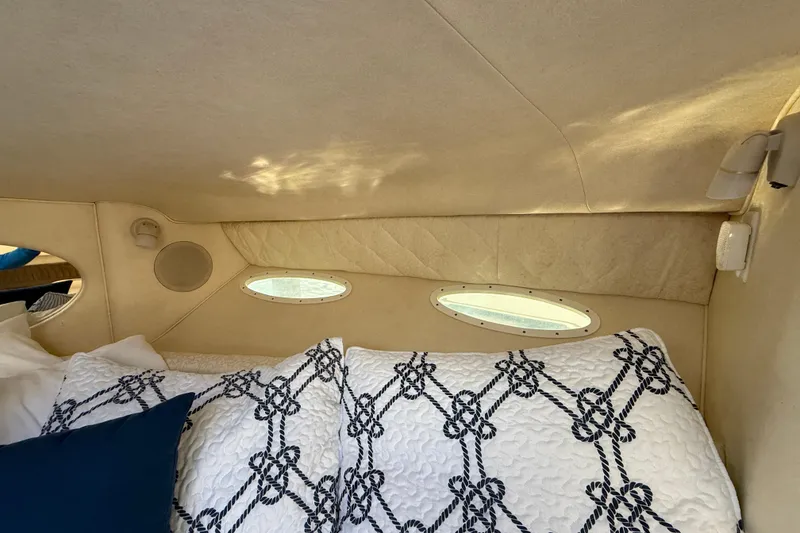 Slide: The Image of Interior cabin of 2001 Sea Ray 310 Sundancer with nautical-themed bedding. - 37