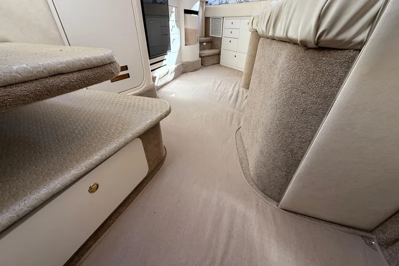 Slide: The Image of Interior of 2001 Sea Ray 310 Sundancer, featuring carpeted steps and storage cabinets. - 41