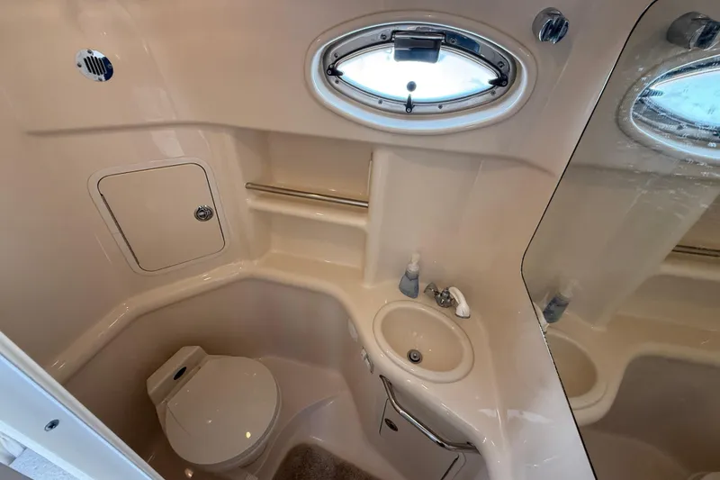 Slide: The Image of Bathroom interior of 2001 Sea Ray 310 Sundancer yacht, featuring sink and toilet. - 42