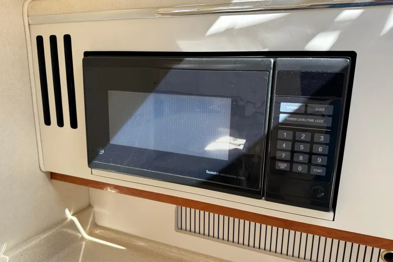Slide: The Image of Built-in microwave in 2001 Sea Ray 310 Sundancer yacht kitchen area. - 46
