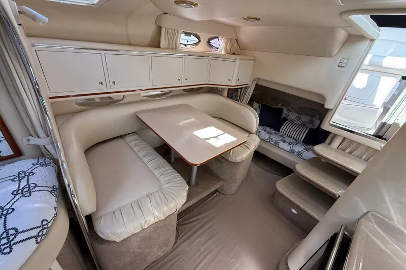 Slide: The Image of 2001 Sea Ray 310 Sundancer interior with cozy seating and elegant cabinetry. - 48