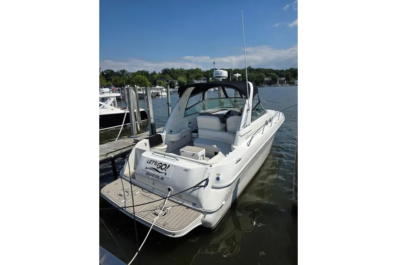 Slide: The Image of 2001 Sea Ray 310 Sundancer docked at a marina under clear blue skies. - 5