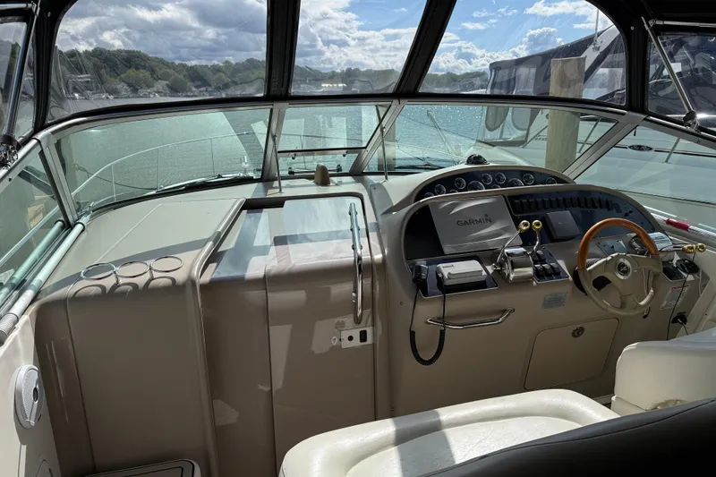 Slide: The Image of 2001 Sea Ray 310 Sundancer cockpit with Garmin navigation, steering wheel, and control panel. - 50