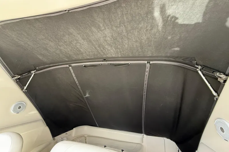 Slide: The Image of 2001 Sea Ray 310 Sundancer boat interior with black canopy and seating area. - 51