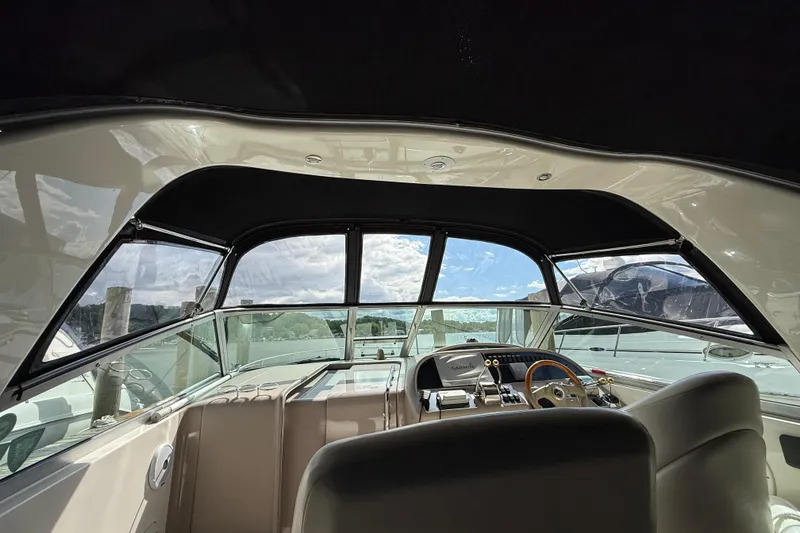 Slide: The Image of Interior view of 2001 Sea Ray 310 Sundancer boat cockpit with steering wheel. - 52