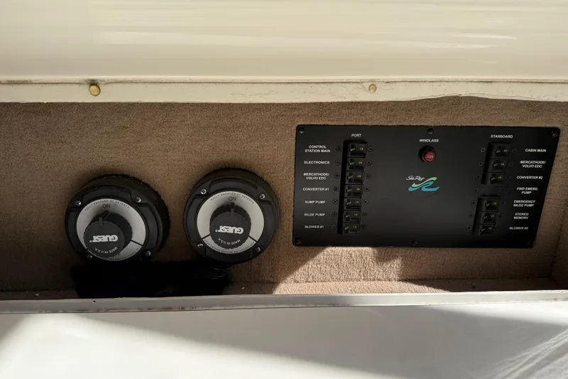 Slide: The Image of Control panel of a 2001 Sea Ray 310 Sundancer boat with switches and gauges. - 53