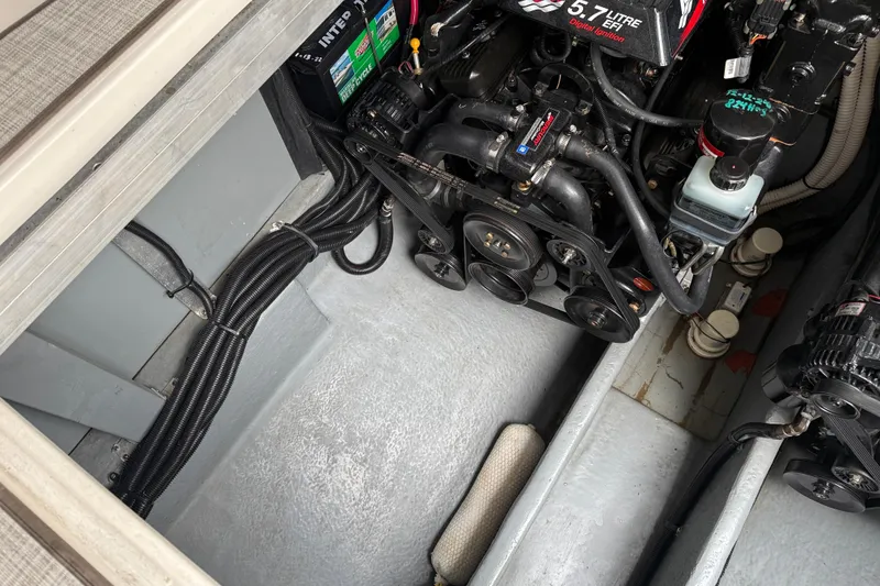 Slide: The Image of Engine compartment of a 2001 Sea Ray 310 Sundancer boat, showcasing a 5.7L EFI engine. - 56