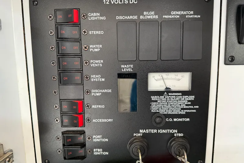 Slide: The Image of Control panel of a 2001 Sea Ray 310 Sundancer boat with switches and ignition keys. - 60