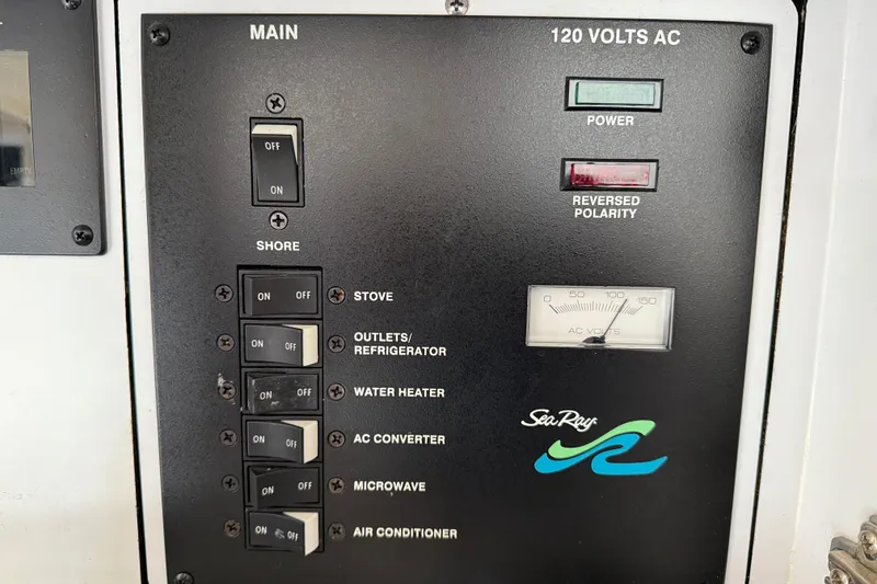 Slide: The Image of Electrical panel of 2001 Sea Ray 310 Sundancer with switches and voltage meter. - 61