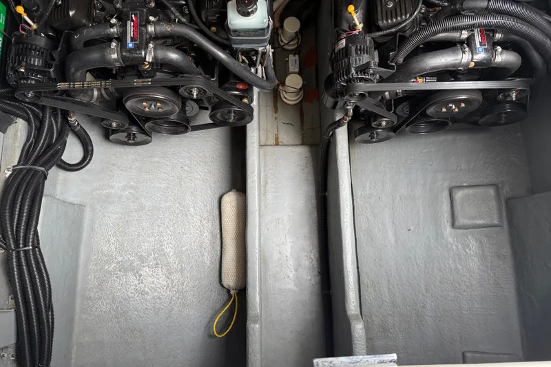 Slide: The Image of Engine compartment of a 2001 Sea Ray 310 Sundancer boat, showcasing dual engines. - 62