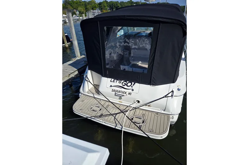 Slide: The Image of 2001 Sea Ray 310 Sundancer docked, rear view with black canopy, Saugatuck, MI. - 7
