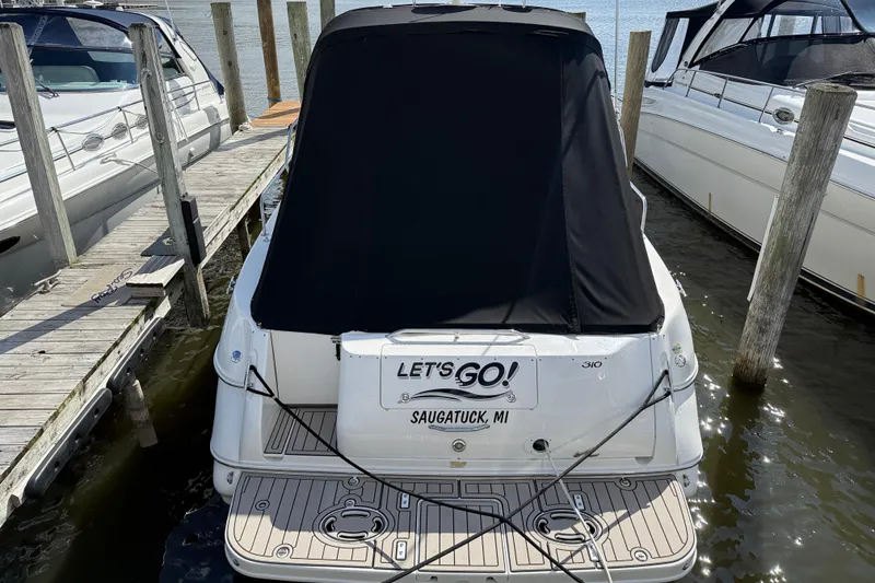 Slide: The Image of 2001 Sea Ray 310 Sundancer docked, rear view with black cover, Saugatuck, MI. - 8