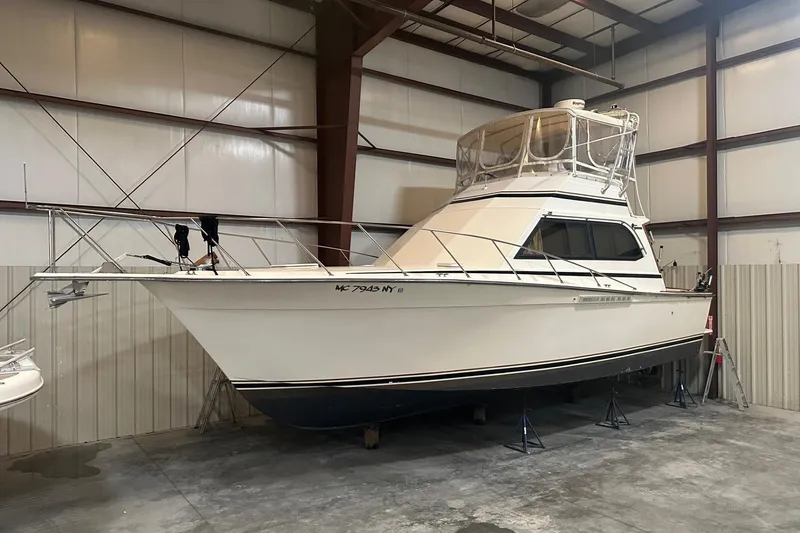 Slide: The Image of 1989 Egg Harbor 37 Convertible yacht in indoor storage, side view. - 0
