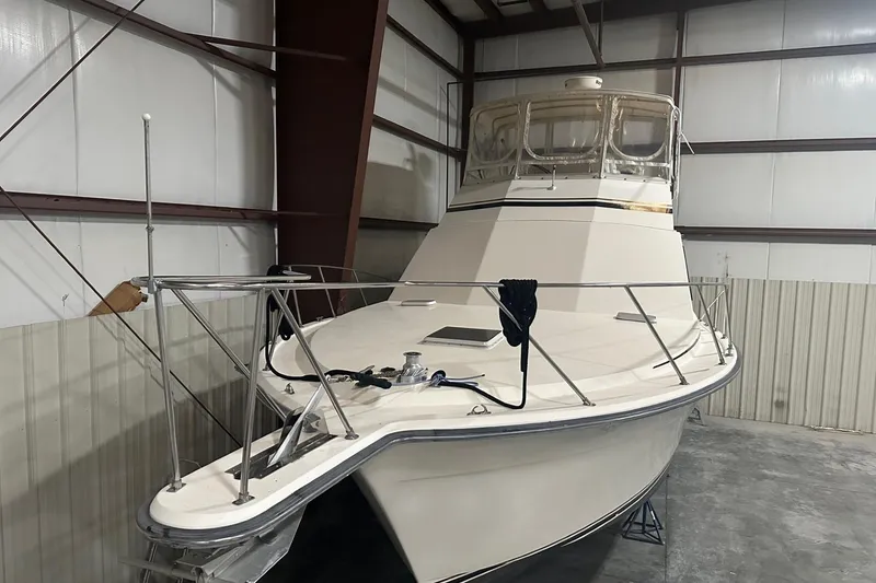 Slide: The Image of 1989 Egg Harbor 37 Convertible boat in storage, showcasing sleek design and sturdy build. - 1