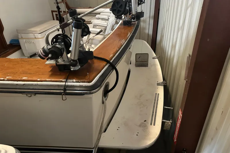 Slide: The Image of 1989 Egg Harbor 37 Convertible boat in storage, featuring fishing equipment. - 11