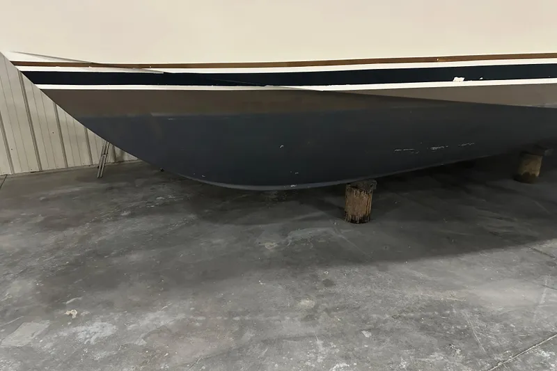 Slide: The Image of 1989 Egg Harbor 37 Convertible boat hull on supports in a storage facility. - 12