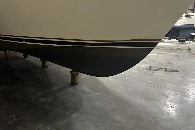 Slide: The Image of 1989 Egg Harbor 37 Convertible boat hull in a storage facility. - 13