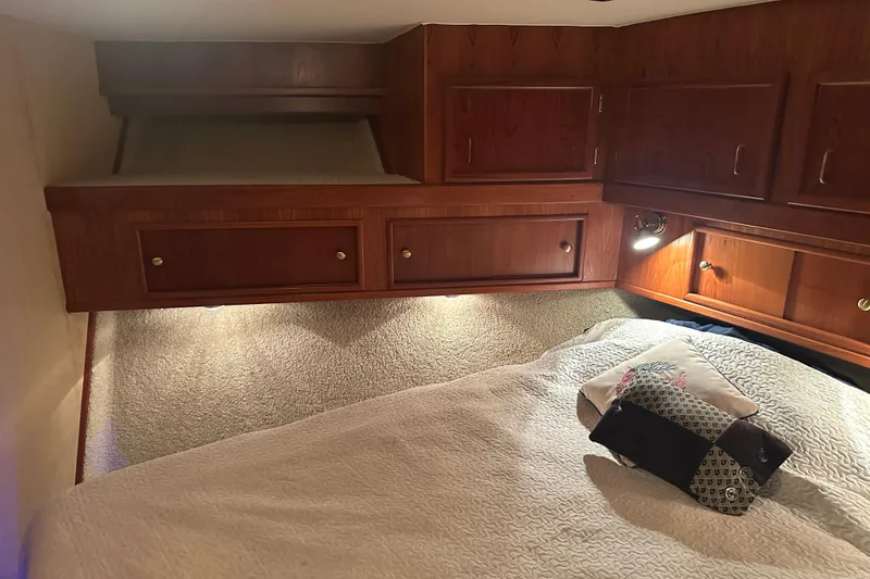 Slide: The Image of Cozy cabin interior of 1989 Egg Harbor 37 Convertible with wood cabinetry and bedding. - 17