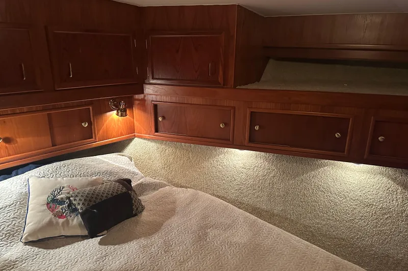 Slide: The Image of Cozy cabin interior of 1989 Egg Harbor 37 Convertible with wooden cabinets and soft lighting. - 18