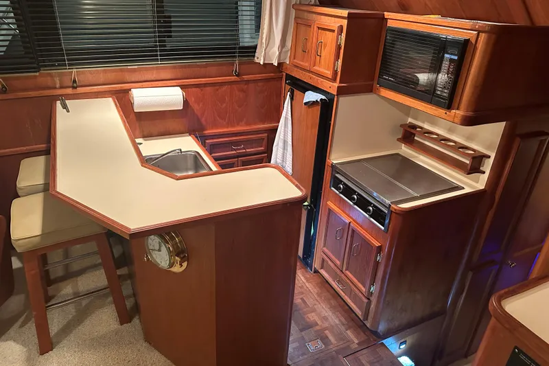 Slide: The Image of 1989 Egg Harbor 37 Convertible yacht kitchen with wood cabinetry, stove, and sink. - 25