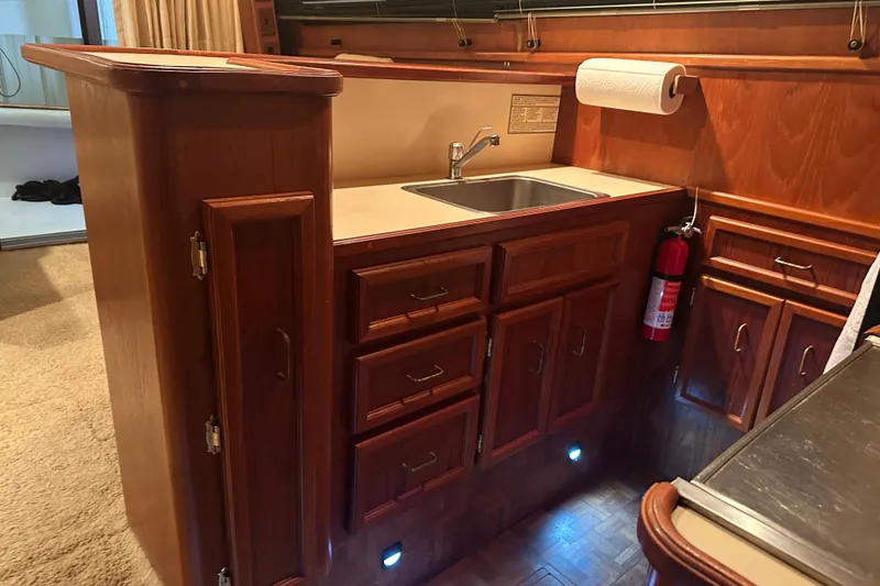 Slide: The Image of 1989 Egg Harbor 37 Convertible yacht kitchen with wooden cabinets and sink. - 26