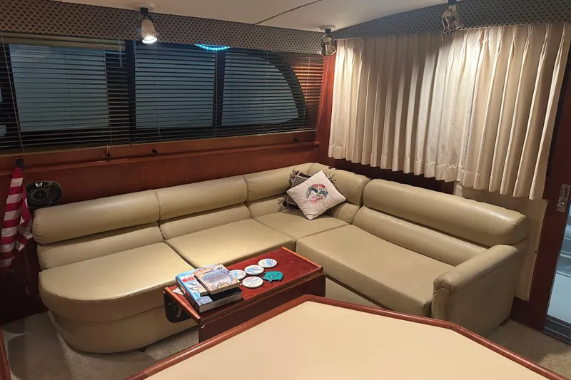 Slide: The Image of Interior of 1989 Egg Harbor 37 Convertible yacht with beige leather seating and wooden accents. - 27