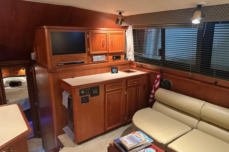 Slide: The Image of Interior of 1989 Egg Harbor 37 Convertible yacht with wood cabinetry and beige seating. - 28