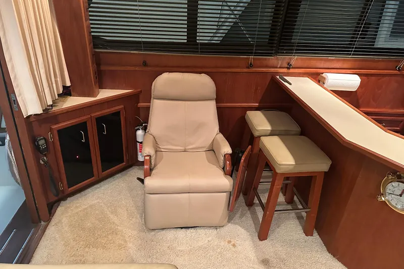 Slide: The Image of Interior of 1989 Egg Harbor 37 Convertible yacht with beige recliner and bar stools. - 29