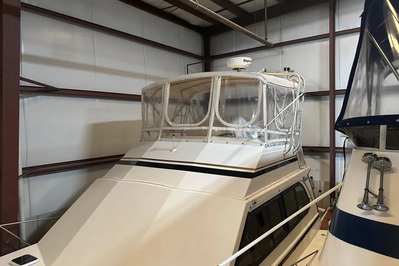 Slide: The Image of 1989 Egg Harbor 37 Convertible yacht in storage, featuring enclosed flybridge. - 3