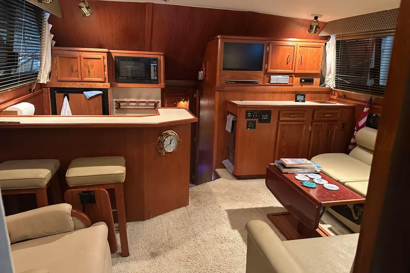 Slide: The Image of Interior of a 1989 Egg Harbor 37 Convertible yacht with wood cabinetry and cozy seating. - 30