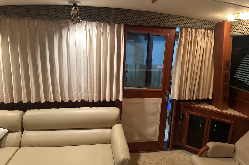 Slide: The Image of Interior of 1989 Egg Harbor 37 Convertible yacht with beige seating and curtains. - 31