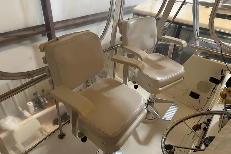 Slide: The Image of Interior of 1989 Egg Harbor 37 Convertible with two white captain's chairs. - 39